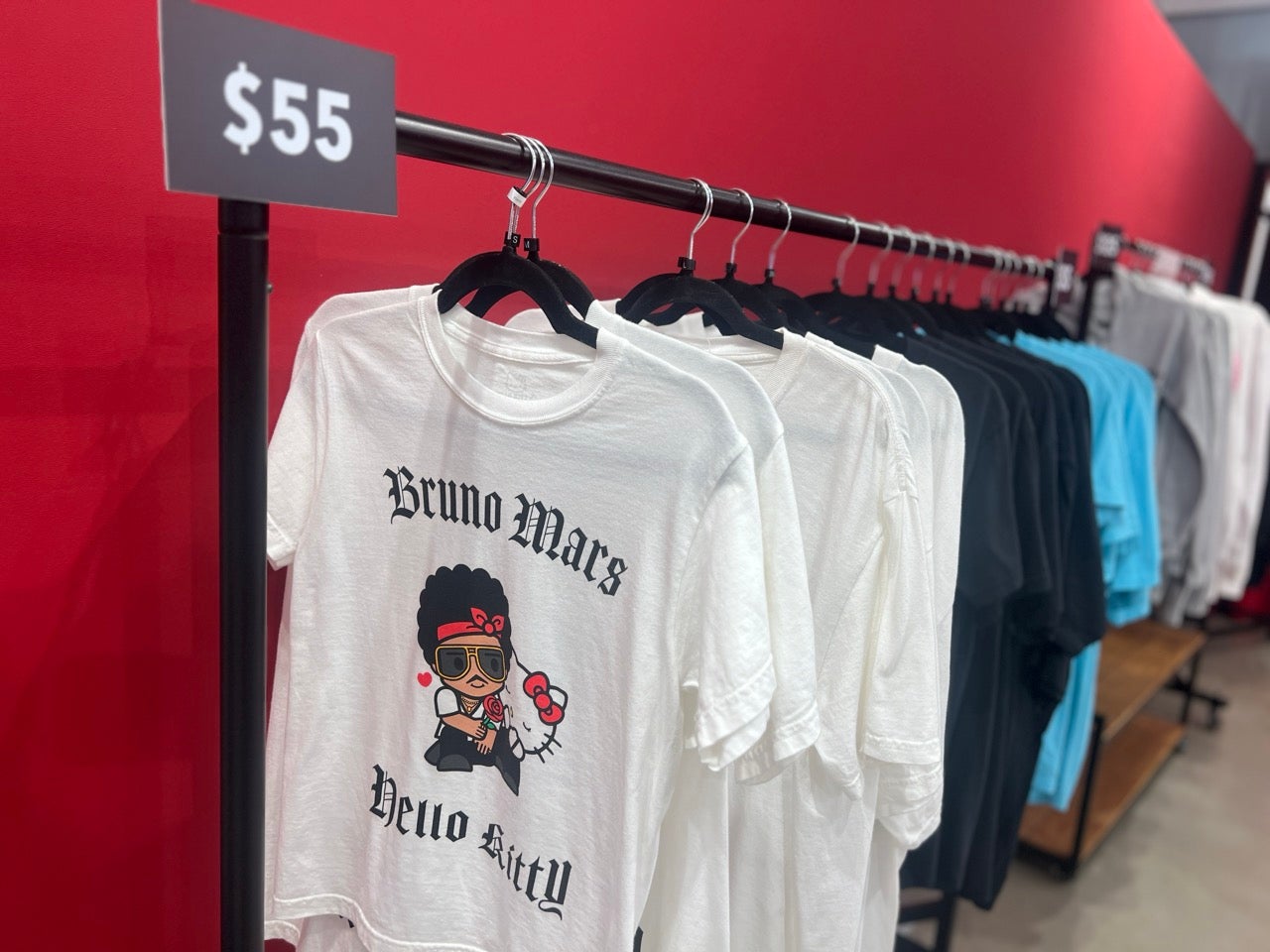 White and Black Bruno Mars Hello Kitty Shirts on a clothing rack.