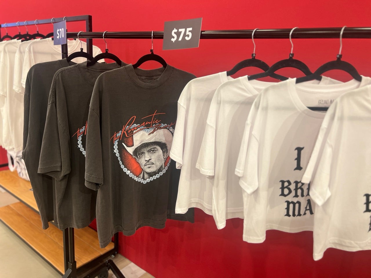 Bruno Mars and Hello Kitty pop-up merch shop black shirts with Bruno Mars in a cowboy hat, and white shirts too.