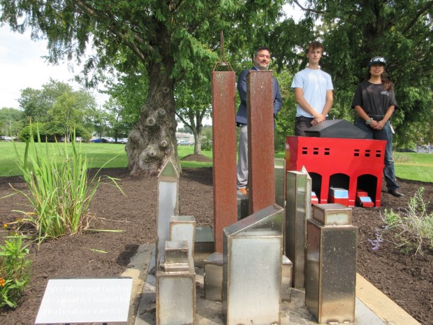 North Montco Technical Career Center Director Darin Van Norman, junior Matt Tomczak and teaching assistant Esther Iglesias pose at the school's September 11th memorial garden, where a new firehouse welded by Tomczak was installed on Thursday, Sept. 10, 2026. (Dan Sokil - MediaNews Group)