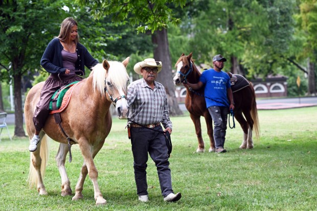 A woman gets a pony ride during the Berks Latin Fest in Reading City Park on Saturday, Sept. 12, 2026.   (BILL UHRICH/READING EAGLE)