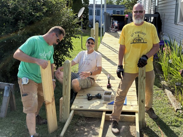 From left, Richie Boden, Joe Hill and Fred Schoppe work on a wheelchair ramp as part of the Birdsboro Shares ministry. (Courtesy of Stuart Wells )