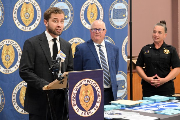 Alex Mann of Malvern, Chester County, an autism advocate, talks about the Blue Envelope program that provides officers with essential information while helping create safer interactions with drivers who may be autistic. Joining him at a press conference in the Caernarvon Township municipal building are Berks County District Attorney John T. Adams and Berks County Sheriff Mandy Miller. (BILL UHRICH/READING EAGLE)