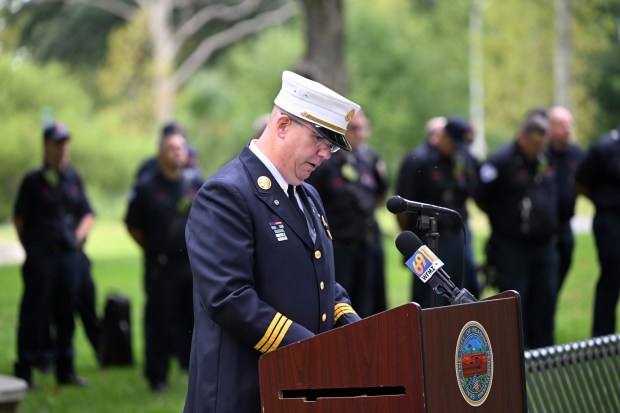 Reading Fire Marshal Jeremy Searfoss reads the names of the 343 New York firefighters who died on Sept. 11, 2001, during Reading's commemoration of the 25th Anniversary on Friday in City Park.   (BILL UHRICH/READING EAGLE)
