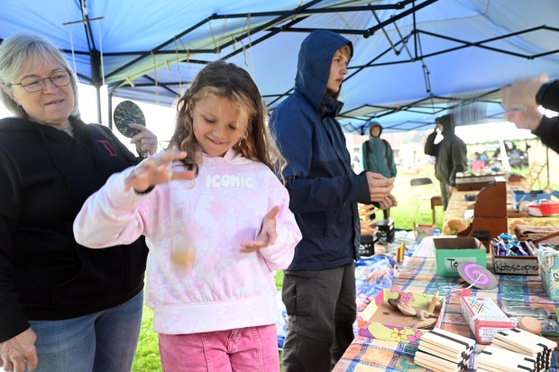 Adalyn Mummolo, 10, of Lenhartsville, granddaughter of Rosemary Falk of Krumsville, left, tries out a yo-yo at the old-time toy display during the Heemet Fescht at the Pennsylvania German Cultural Heritage Center at Kutztown University on Saturday, Sept. 26, 2026. (BILL UHRICH/READING EAGLE)