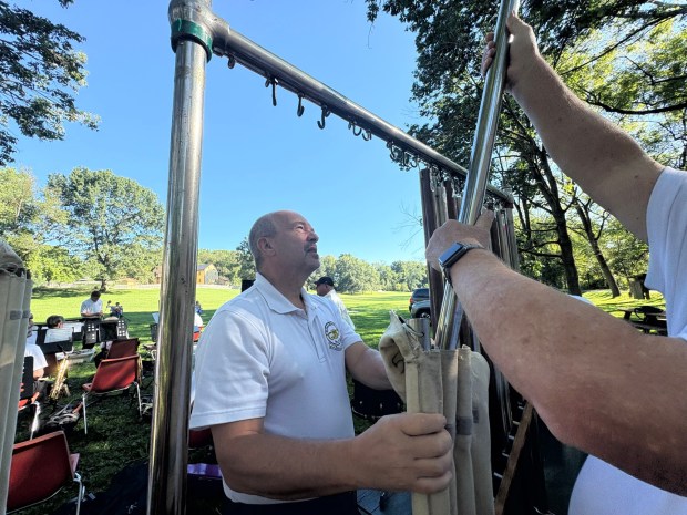 Mark Brumbach helps assemble the chimes for the annual Ringgold Band Labor Day performance by the Red Bridge at the Berks County Heritage Center on Monday, Sept. 7, 2026. (BILL UHRICH/READING EAGLE)