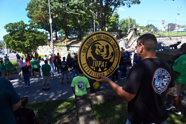 A union member holds a sign during a Labor Day flag raising event in City Park on Monday, Sept. 7, 2026. (BILL UHRICH/READING EAGLE)
