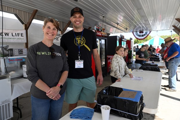 Kristin Lutz and Jordan Mease, one of the pastors, supervise the New Life Bible Fellowship Church soda and ice cream stand at the Oley Valley Community Fair. (BILL UHRICH/READING EAGLE)