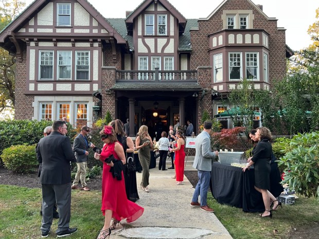 Guests socialize at the Yuengling Mansion during the cocktail hour of the Masquerade at the Mansion on Saturday, Oct. 4, 2025. (HYUN SOO LEE/STAFF PHOTO)