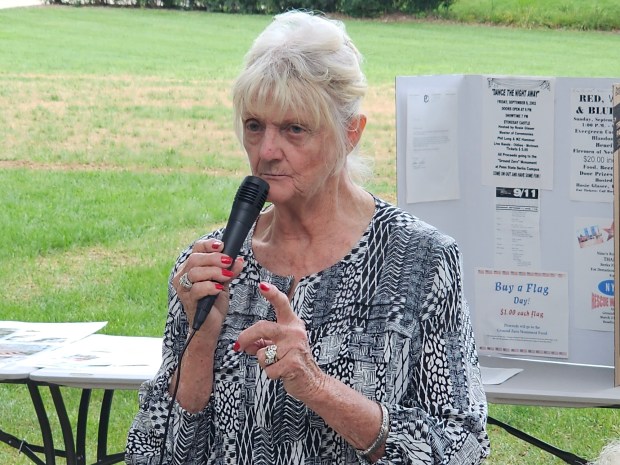 Rose Glaser of Muhlenberg Township, who led the effort to erect a granite memorial on the Penn State Berks Campus honoring the victims of and responders to the Sept. 11, 2001, terrorist attacks, speaks at a service Friday in front of the memorial. (MICHELLE LYNCH/READING EAGLE)