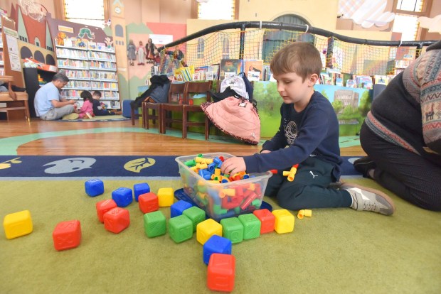 Jack Lee, 5, of Waymart, digs through building pieces at the Lackawanna County Children's Library in Scranton Tuesday, March 24, 2026. (SEAN MCKEAG / STAFF PHOTOGRAPHER)
