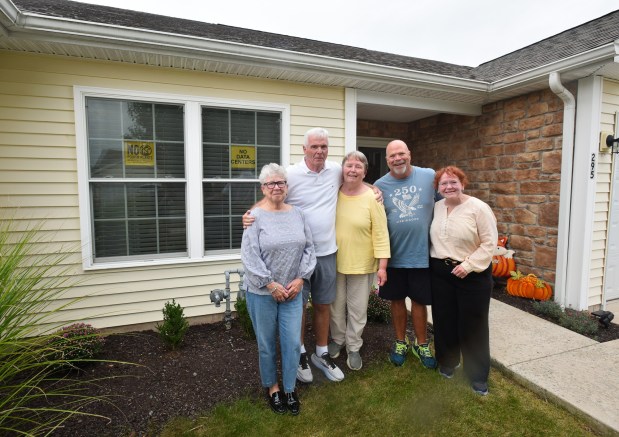 Residents of the Highlands at Archbald Kim Nudelman, Jim and Karen Timmons, Andy Jerome, and Meg Nudelman stand in front of the Kim and Meg Nudelman's residence in Archbald Thursday, September 17, 2026. (SEAN MCKEAG / STAFF PHOTOGRAPHER)