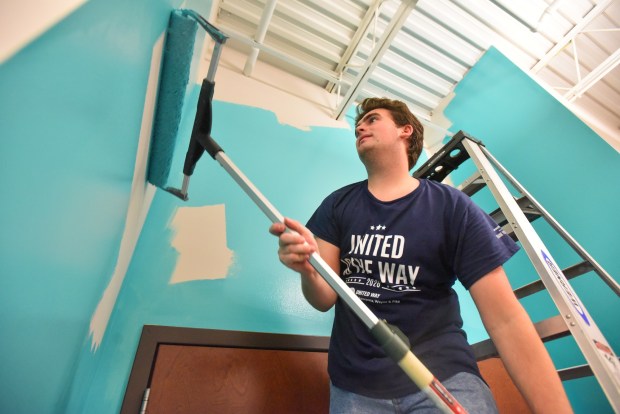 Posture Interactive Production Coordinator Dominic Angeloni paints the walls inside of Outreach Center for Community Resources in Scranton for the United Way Day of Caring in Scranton Thursday, September 3, 2026. (SEAN MCKEAG / STAFF PHOTOGRAPHER)