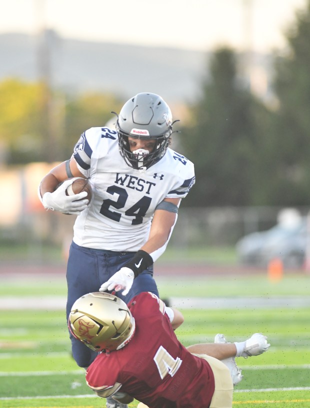 Pocono Mountain West's Christian Stiehler, 24, approaches Scranton's Tony Battaglia at Veterans Memorial Stadium in Scranton Friday, Aug. 22, 2025. (Sean McKeag/Times-Tribune)