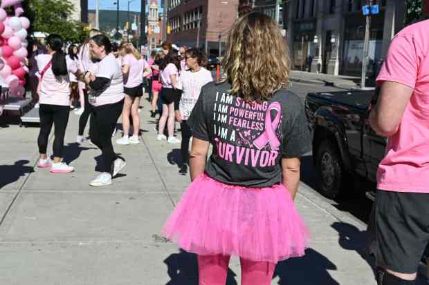 Erika Wenger, of Moosic, sports a colorful pink outfit for a past Paint the Planet Pink event in Scranton. Wenger's T-shirt is a reminder that many of those in attendance are cancer survivors, themselves. (GERI GIBBONS/STAFF PHOTO)