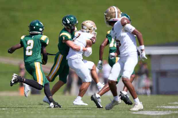 Bethlehem Catholic's Tyre Lewis  is tackled by Allentown Central Catholic's Grayson Schmell on Saturday, Sept. 5, 2026, at J. Birney Crum Stadium. (David Garrett/Special to The Morning Call)