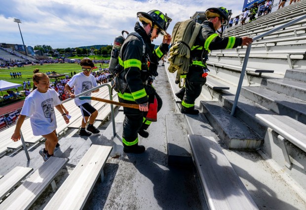 City of Bethlehem firefighters Kyle Jimenez and Kyle Pochek and Liberty students Hannah Broadhead and Anthony Zappa climb the stadium steps Friday, Sept. 11, 2026, during "The Climb" event at BASD Stadium in Bethlehem. Bethlehem Area high school students, staff, first responders, military personnel and community partners came together for a student-centered 9/11 remembrance event in which students from Freedom and Liberty High Schools climbed the stadium steps, walked the track and engaged in other activities to remember the lives lost 25 years ago. The goal was to climb 2,200 stairs or walk three miles, symbolizing 110 flights of stairs in one of the World Trade Center towers. (April Gamiz/The Morning Call)