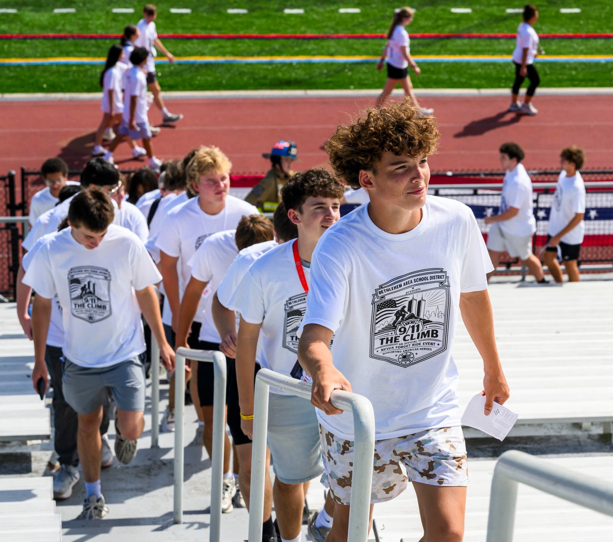 Freedom student Evan Vernon and others climb the stadium stairs Friday, Sept. 11, 2026, during "The Climb" event at BASD Stadium in Bethlehem. Bethlehem Area high school students, staff, first responders, military personnel and community partners came together for a student-centered 9/11 remembrance event in which students from Freedom and Liberty High Schools climbed the stadium steps, walked the track and engaged in other activities to remember the lives lost 25 years ago. The goal was to climb 2,200 stairs or walk three miles, symbolizing 110 flights of stairs in one of the World Trade Center towers.(April Gamiz/The Morning Call)