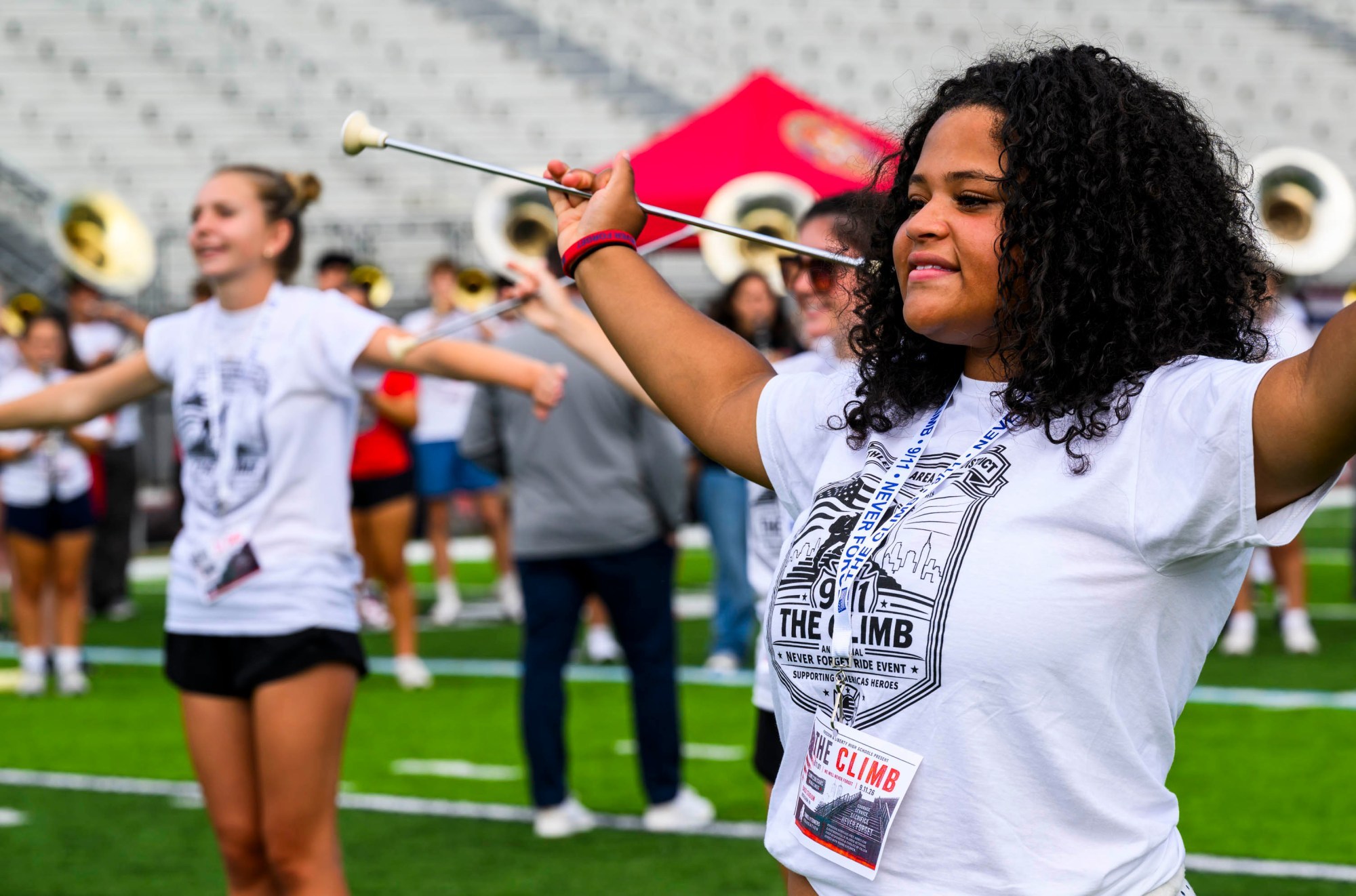 Liberty majorette Mariah Randolph marches with others Friday, Sept. 11, 2026, during "The Climb" event at BASD Stadium in Bethlehem. Bethlehem Area high school students, staff, first responders, military personnel and community partners came together for a student-centered 9/11 remembrance event in which students from Freedom and Liberty High Schools climbed the stadium steps, walked the track and engaged in other activities to remember the lives lost 25 years ago. The goal was to climb 2,200 stairs or walk three miles, symbolizing 110 flights of stairs in one of the World Trade Center towers. (April Gamiz/The Morning Call)