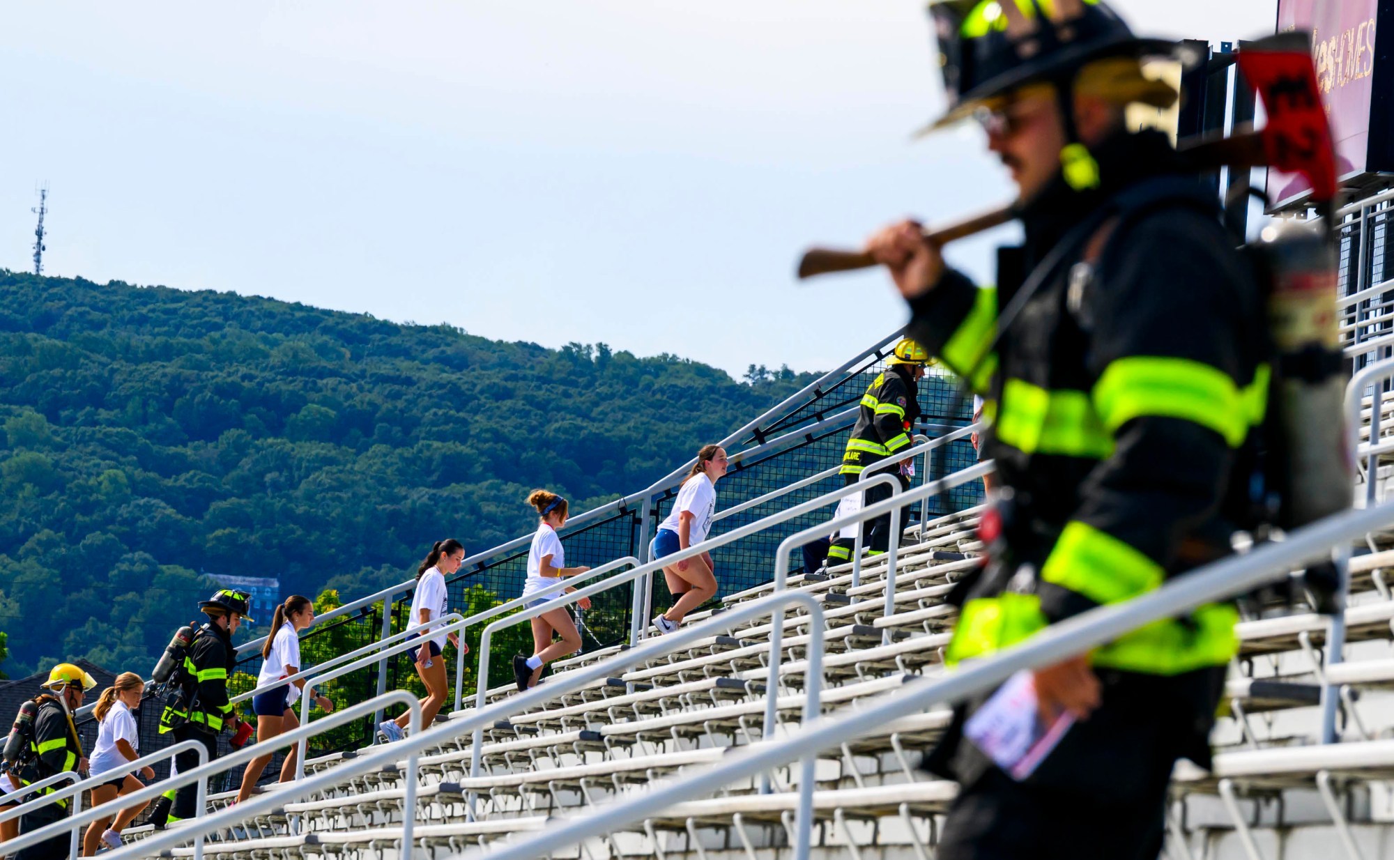 Students climb the stadium steps with local firefighters Friday, Sept. 11, 2026, at BASD Stadium in Bethlehem. Bethlehem Area high school students, staff, first responders, military personnel and community partners came together for a student-centered 9/11 remembrance event in which students from Freedom and Liberty High Schools climbed the stadium steps, walked the track and engaged in other activities to remember the lives lost 25 years ago. The goal was to climb 2,200 stairs or walk three miles, symbolizing 110 flights of stairs in one of the World Trade Center towers. (April Gamiz/The Morning Call)