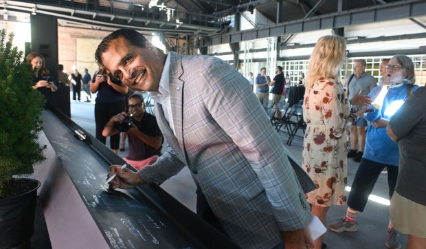 Bob Begliomini, Executive Vice President of Jefferson Health- Lehigh Valley Region signs a beam Friday, Sept. 18, 2026, that will ultimately become part of the revitalized building as ArtsQuest celebrates its construction milestone for the Lehigh Valley Health Network, part of Jefferson Health Turn & Grind Shop at SteelStacks. (Monica Cabrera/The Morning Call)
