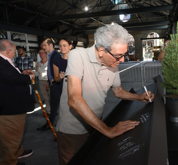 Jeff Parks signs a steel beam Friday, Sept. 18, 2026, that will ultimately become part of the revitalized Jefferson Health Turn & Grind Shop at SteelStacks in Bethlehem. (Monica Cabrera/The Morning Call)