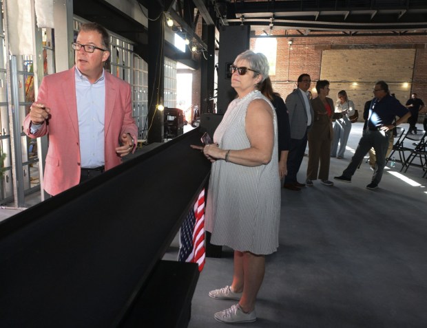 ArtsQuest Chief Operating Officer, Curt Mosel, left, attends a beam-signing ceremony Friday, Sept. 18, 2026, that will ultimately become part of the revitalized building as ArtsQuest celebrates its construction milestone for the Lehigh Valley Health Network, part of Jefferson Health Turn & Grind Shop at SteelStacks. (Monica Cabrera/The Morning Call)
