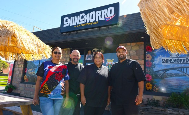 Carmen Cintron, left to right, Armando Rodriguez, cook and food prep., Yesenia Westerband-Rodriguez, owner, and Armando Rodriguez-Cintron, restaurant manager, serve up Puerto Rican specialties Thursday, Sept. 24, 2026, at Chinchorro restaurant in Easton. Like their sister food truck La Frikitona, Chinchorro serves food items such as tostones, mofongo, sancocho, canoas and pastelillos. (Monica Cabrera/The Morning Call)