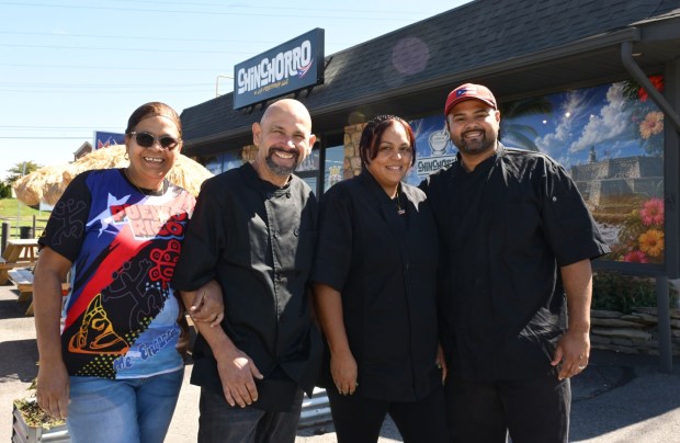 Carmen Cintron, left to right, Armando Rodriguez, cook and food prep., Yesenia Westerband-Rodriguez, owner, and Armando Rodriguez-Cintron, restaurant manager, serve up Puerto Rican specialties Thursday, Sept. 24, 2026, at Chinchorro restaurant in Easton. Like their sister food truck La Frikitona, Chinchorro serves food items such as tostones, mofongo, sancocho, canoas and pastelillos. (Monica Cabrera/The Morning Call)