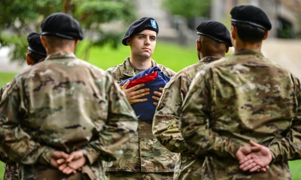 Cadet Joseph Colucci holds the furled American flag as Lehigh University and the Steel Battalion Army ROTC Program hold their annual 9/11 memorial event Friday, Sept. 11, 2026, in Bethlehem, to mark the 25th anniversary of the terror attacks. The ceremony included a flag raising, moment of silence and the planting of the 2,977 American flags to honor the lives lost. (Monica Cabrera/The Morning Call)