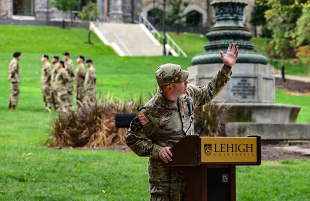 Major Christopher Curran, professor of Military Science addresses attendees gesturing to the sky while speaking about United Airlines Flight 93 during the annual 9/11 memorial event held by Lehigh University and the Steel Battalion Army ROTC Program on Friday, Sept. 11, 2026, in Bethlehem, to mark the 25th anniversary of the terror attacks. The ceremony included a flag raising, moment of silence and the planting of the 2,977 American flags to honor the lives lost. (Monica Cabrera/The Morning Call)