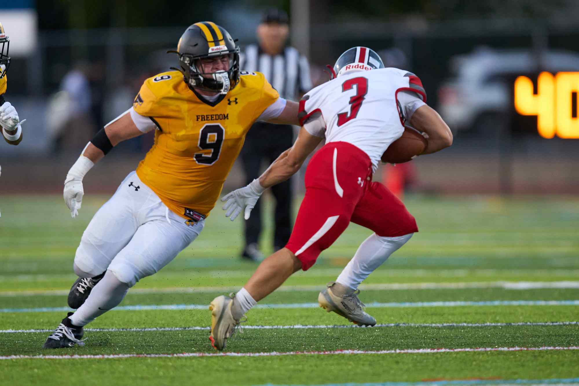 Parkland's Jackson Geroulo is tackled by Freedom's Michael Baker on Friday, Sept. 4, 2026, at Bethlehem School District Stadium. (David Garrett/Special to The Morning Call)