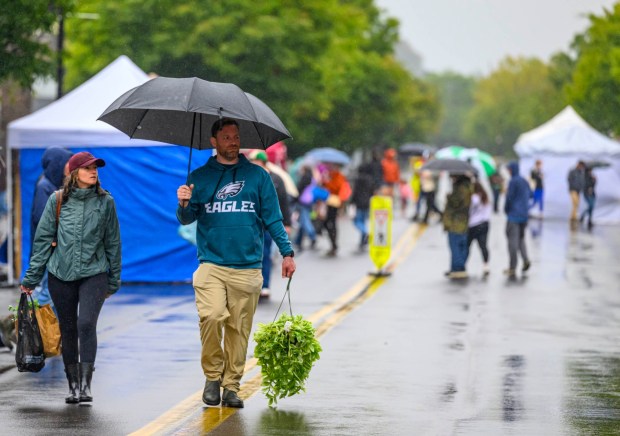 Marlena Wendrick and AJ Diaz carry plants, including a tradescantia, Sunday, Sept. 20, 2026, during the Lehigh Valley Wicked Plant Festival at the ArtsQuest Center at SteelStacks in Bethlehem. (April Gamiz/The Morning Call)