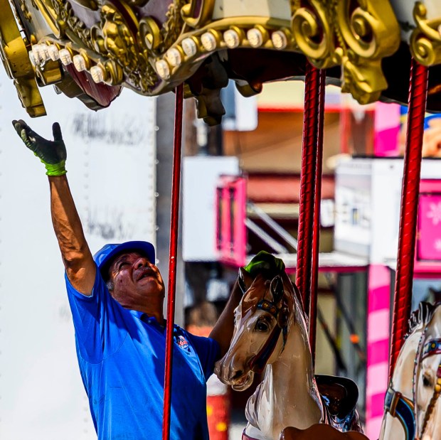 A worker assembles parts of the merry-go-round ride Tuesday, Sept. 1, 2026, at the Allentown Fairgrounds. The 174th Allentown Fair opens Wednesday and runs through Labor Day. (April Gamiz/The Morning Call)