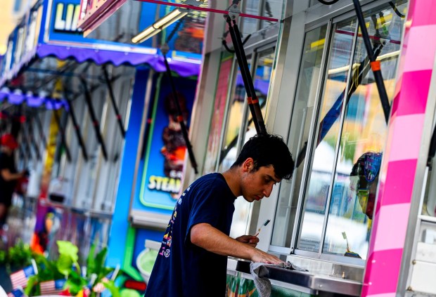 Workers prepare rides, games, and food areas the day before opening day of the Allentown Fair on Tuesday, Sept. 1, 2026, at the Allentown Fairgrounds. The 174th fair opens Wednesday and runs through Labor Day. (April Gamiz/The Morning Call)