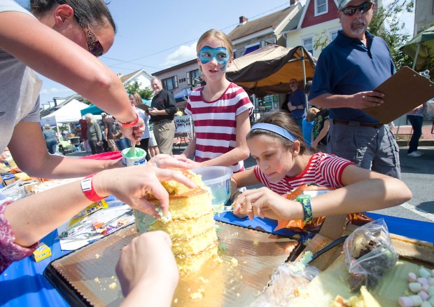 Naomi Sharpless, 11, of Emmaus (left) and Sarah Greene, 11, of Emmaus, participate in the cake decorating contest during the annual Farewell to Summer Festival in the Emmaus Triangle on Sunday, September 10, 2017. The event features crafts, music, food, fun and games,// (Harry Fisher / The Morning Call) mc-nws-emmaus-end-summer-festival