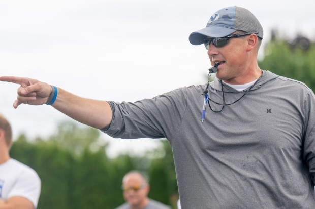 Nazareth coach Tom Falzone talks to his players as they run drills Tuesday, August 18, 2026, during Nazareth High School football practice in Nazareth. (Jonathan Broady/Special to The Morning Call)