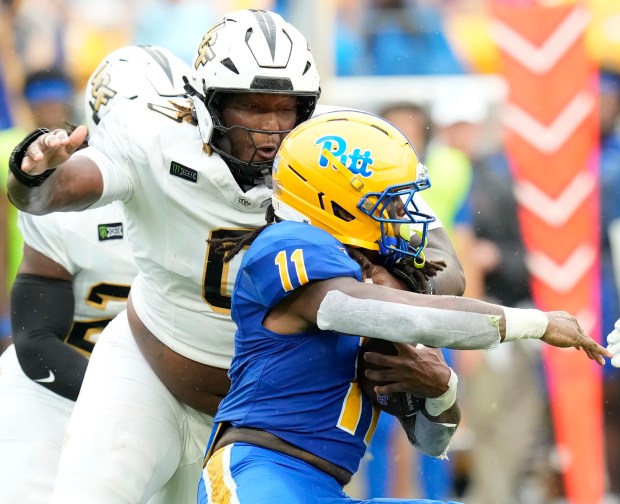 UCF defensive tackle Horace Lockett Jr. (0) puts pressure on Pittsburgh running back La'Vell Wright during the first half of their game on Saturday at Acrisure Stadium. (Matt Freed/Pittsburgh Post-Gazette)