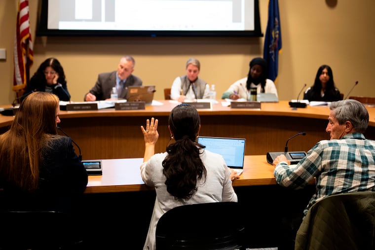 Members of the Lower Merion Board of School Directors speak with attendees at a school board meeting on Monday, May 11, 2026, in Ardmore, Pa. (AP Photo/Joe Lamberti)