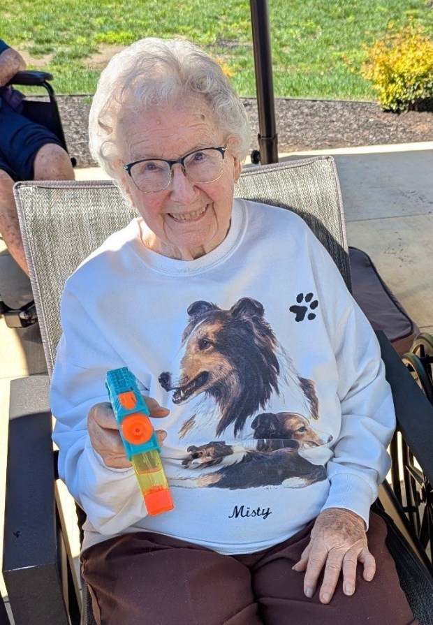 Care Center resident Barbara Griesemer is all smiles with her water pistol. (Courtesy of The Heritage of Green Hills)