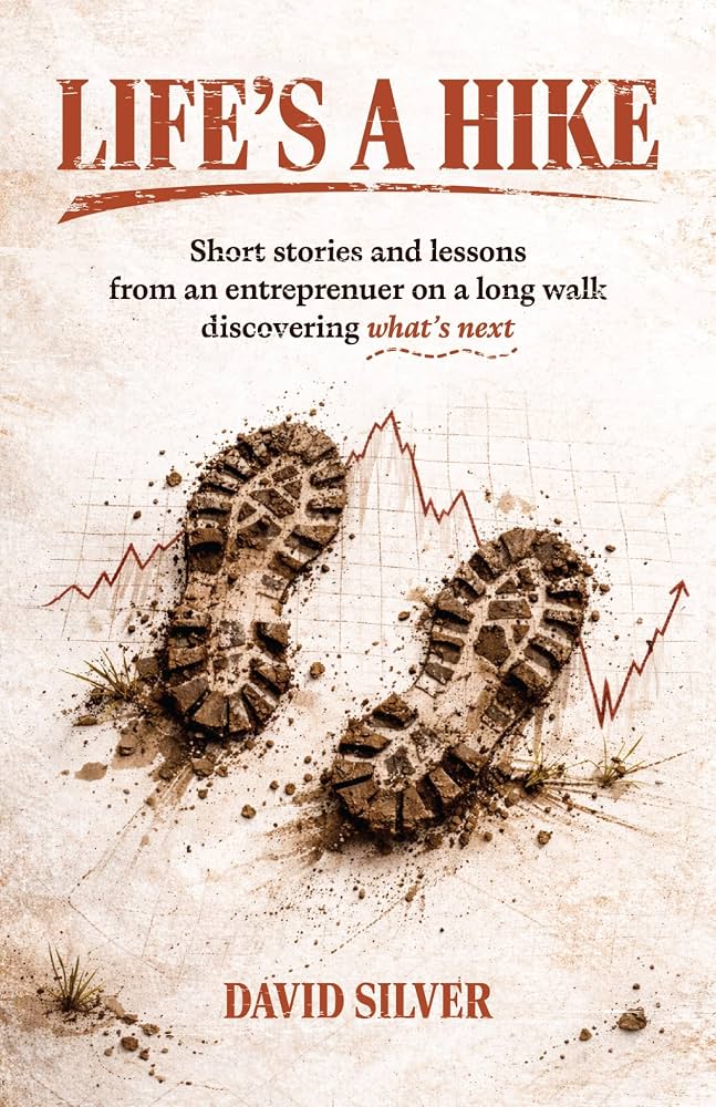 Book cover for “Life’s a Hike” by David Silver, featuring muddy boot prints, grass, and a faint upward-trending graph in the background. Subheading discusses entrepreneurial life lessons.
