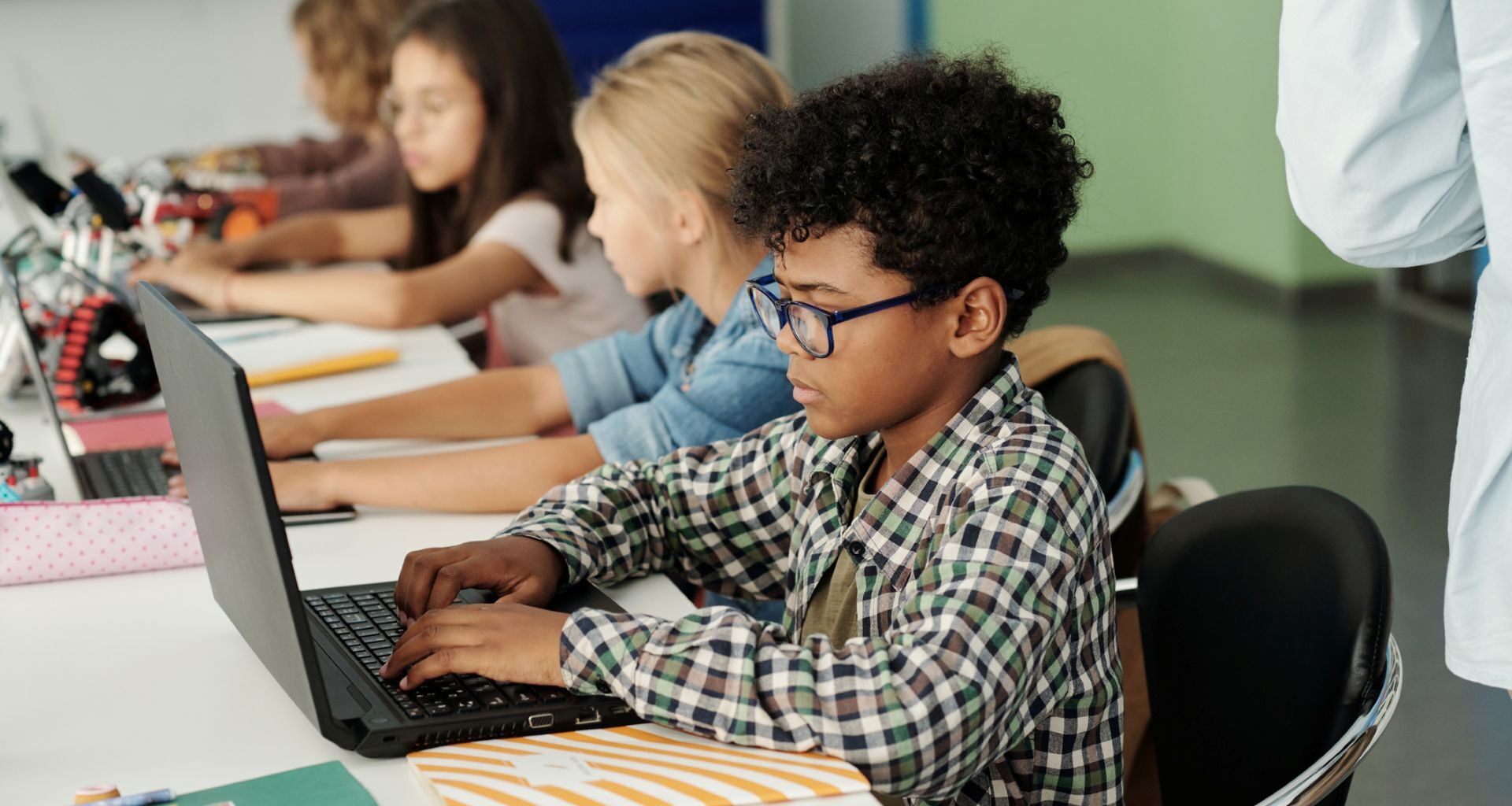 School students working on laptops.