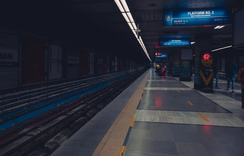 A dimly lit metro station platform with passengers waiting, showcasing urban public transportation. (stock photo via Pexels)