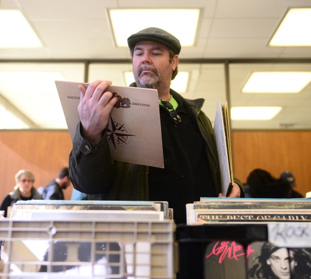 Mike Dempsey, of Bethlehem, looks at a record as he looks for materials to purchase. The Lehigh Valley Punk Rock Flea Market took place at the Bethlehem Public Library Saturday in effort to raise money for the renovation of the Bob Cohen Room. The sale featured 21,000 CDs and vinyl records along with other goods from various vendors. 02/17/18//(Amy Herzog /THE MORNING CALL )