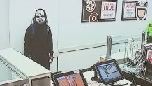 A still photo of a masked man police identified as Zymire Hughes.