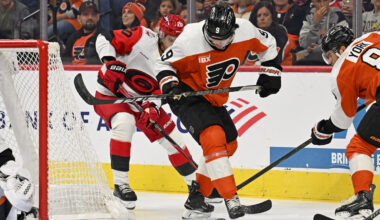 Oct 3, 2026; Philadelphia, Pennsylvania, USA; Philadelphia Flyers defenseman Jamie Drysdale (9) battles for the puck with Carolina Hurricanes center Sebastian Aho (20) during the first period at Xfinity Mobile Arena.