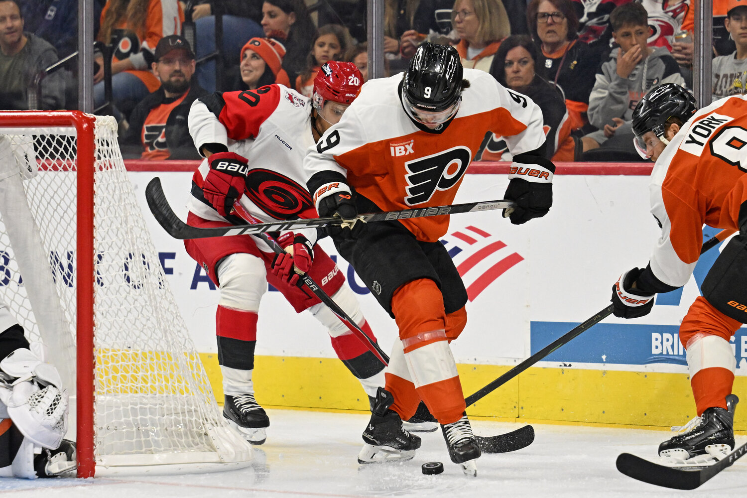 Oct 3, 2026; Philadelphia, Pennsylvania, USA; Philadelphia Flyers defenseman Jamie Drysdale (9) battles for the puck with Carolina Hurricanes center Sebastian Aho (20) during the first period at Xfinity Mobile Arena.