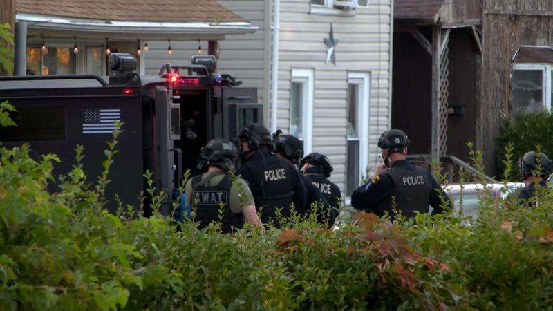 In this image from video provided by WJET, police gather outside the scene of a shooting in Erie, Pa., on Friday evening, Oct. 9, 2026. (Matt Barnum/WJET via AP)