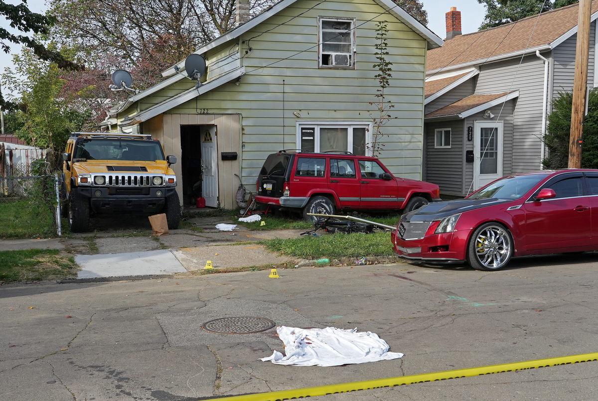 A bloodied sheet lies behind police barrier tape at a house where nine people were confirmed dead in what was described as a mass shooting in Erie, Pennsylvania, U.S. October 10, 2026. Greg Wohlford/USA Today via REUTERS.