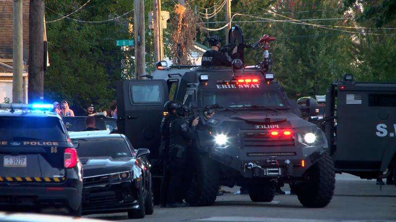 In this image from video provided by WJET, police gather outside the scene of a shooting in Erie, Pa., on Friday evening, Oct. 9, 2026. (Matt Barnum/WJET via AP)