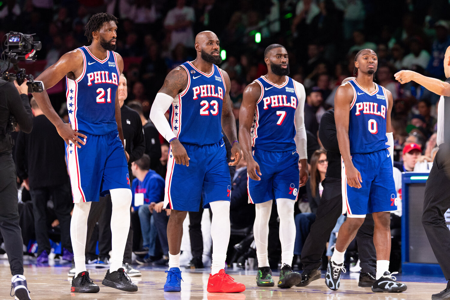 Philadelphia 76ers Joel Embiid (21) and LeBron James (23) and Jaylen Brown (7) and Tyrese Maxey (0) walk back on the court after a break in action against the Cleveland Cavaliers during the fourth quarter at Xfinity Mobile Arena.